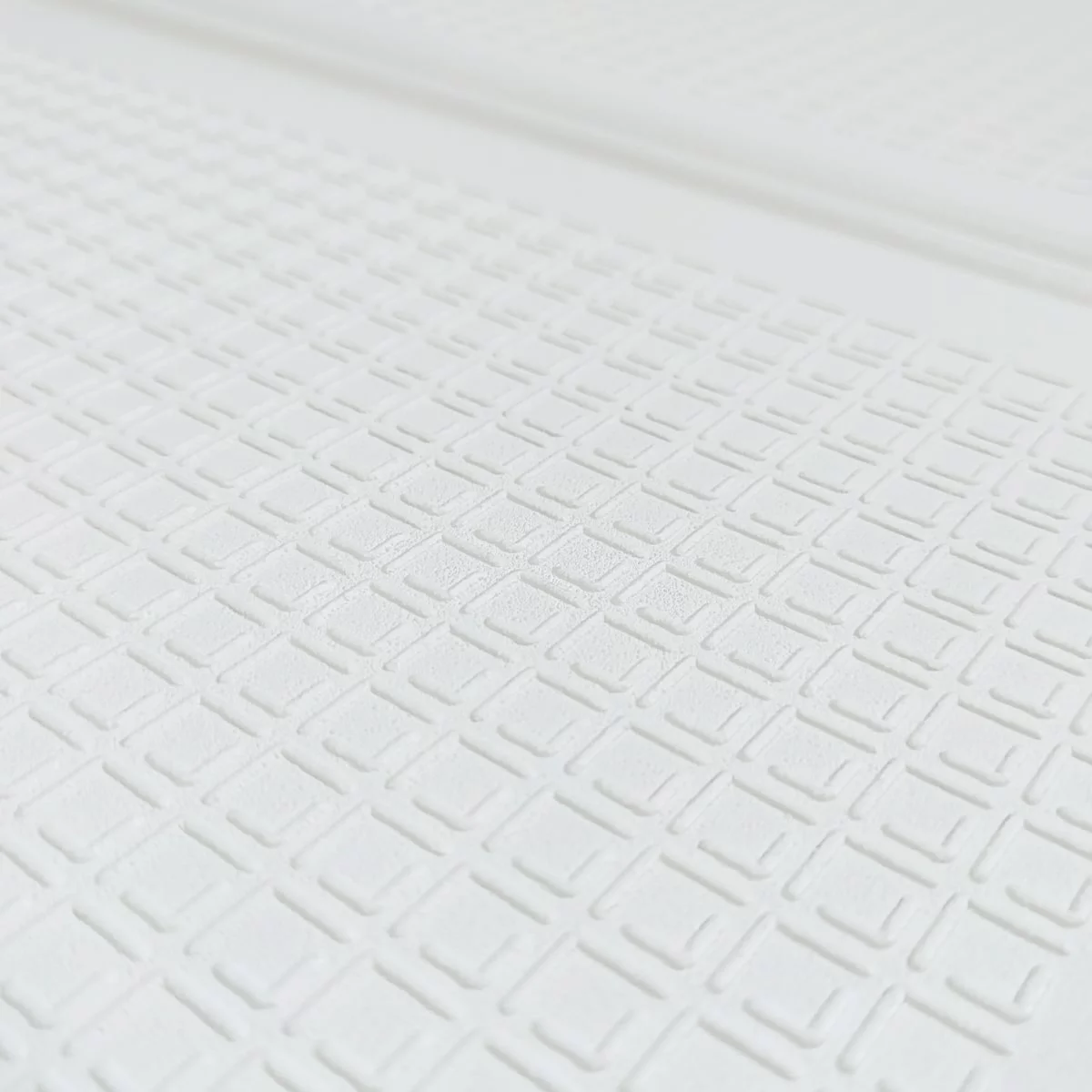 Крупний план тиснення на білому килимку EVA — антиковзна текстура